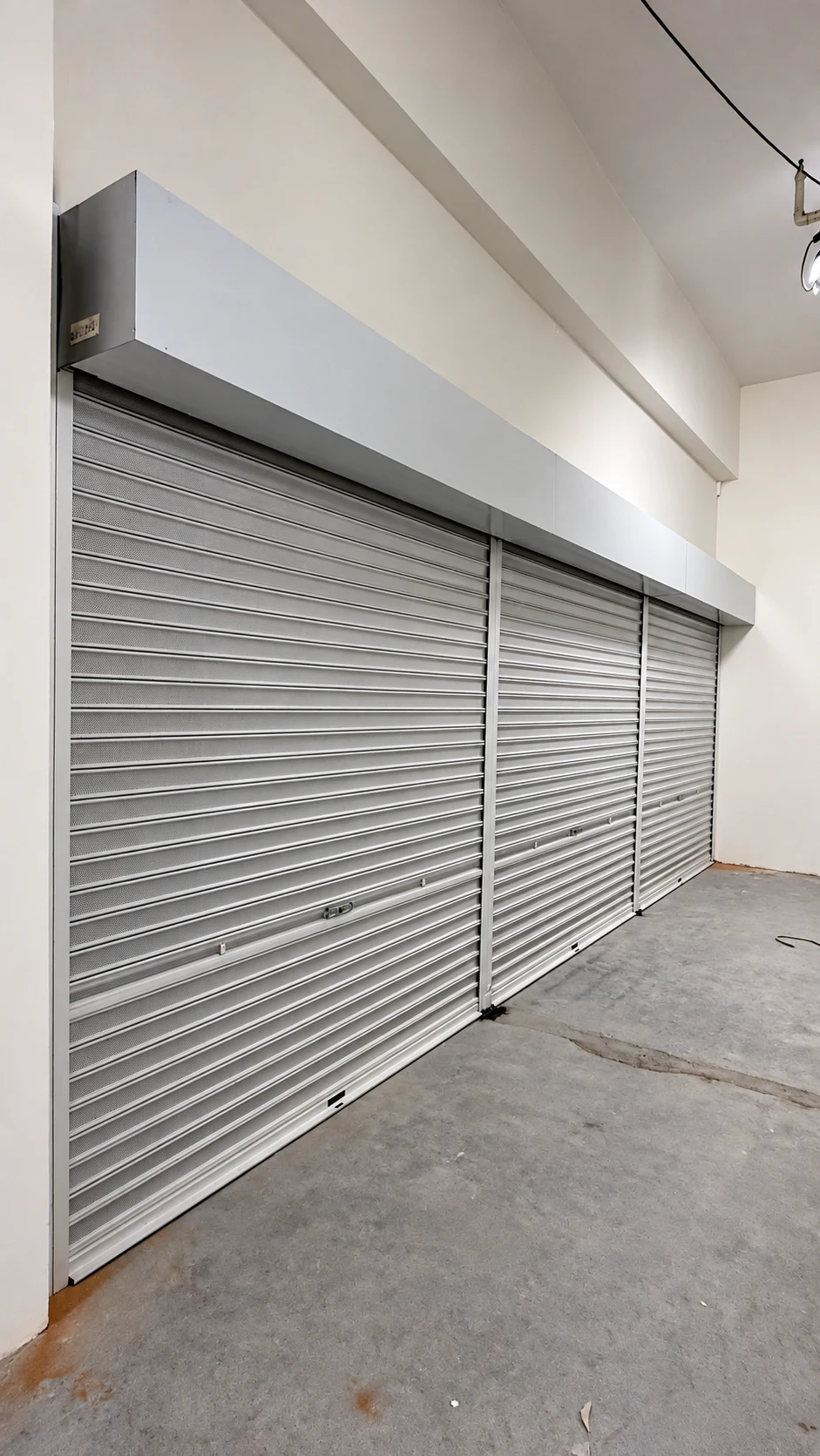 Three roller shutter openings in a commercial interior, photographed during A1 work