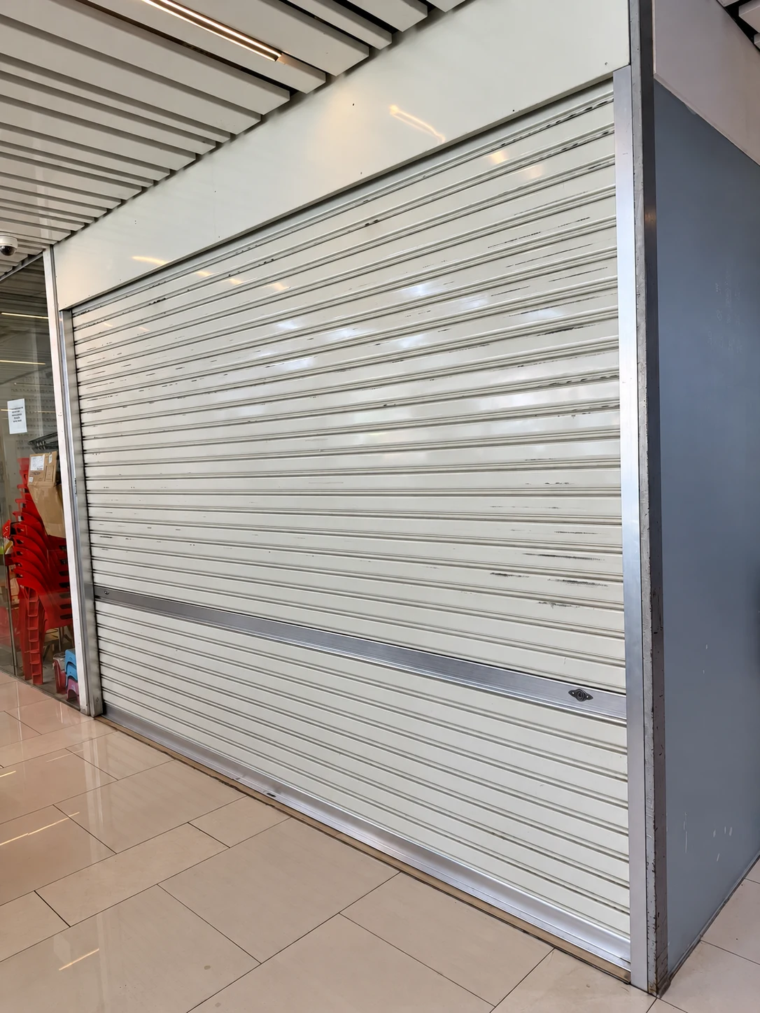 A shutter curtain, bottom rail and shopfront frame photographed during A1 work