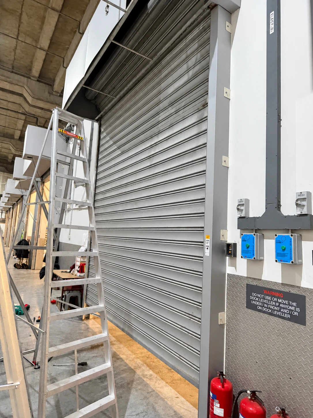 Access equipment alongside an existing roller shutter