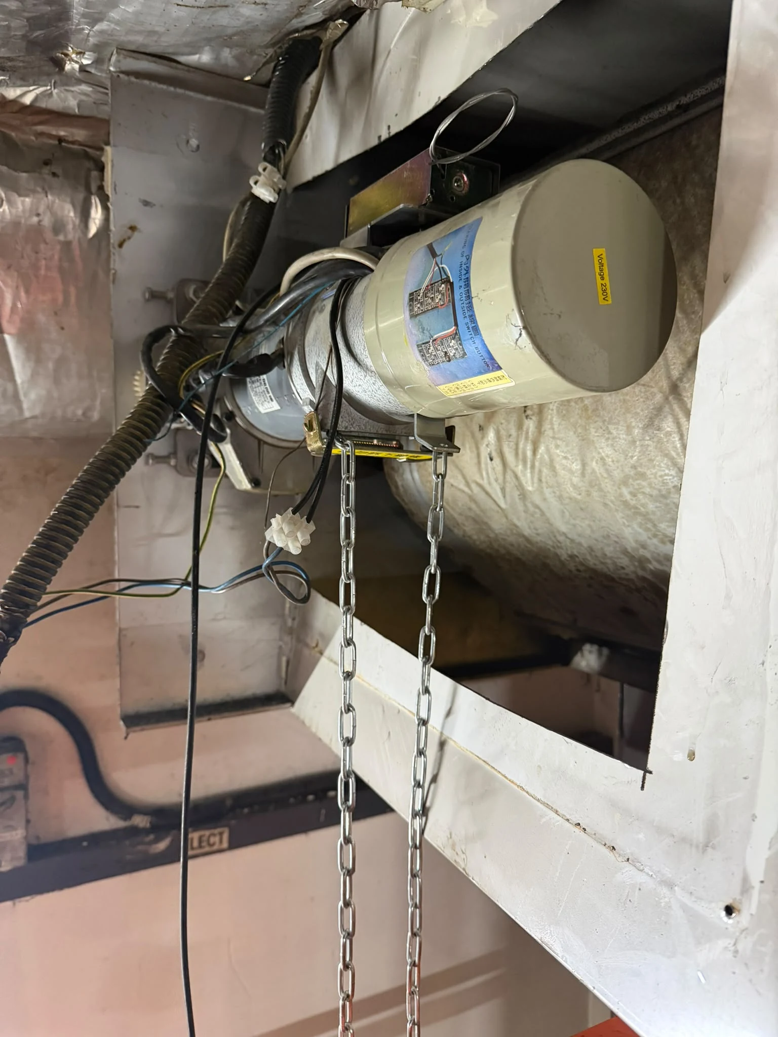 An installed shutter motor drive and manual chain photographed during A1 work